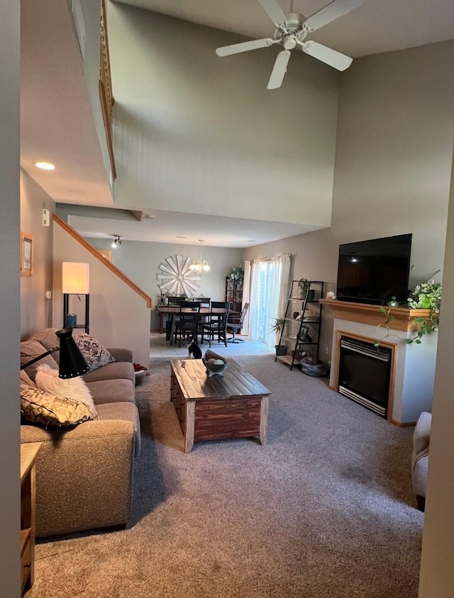 3799 Village Run Dr Unit 512, Des Moines, IA 50317 - living room with carpet, a towering ceiling, a fireplace, ceiling fan, and a chandelier