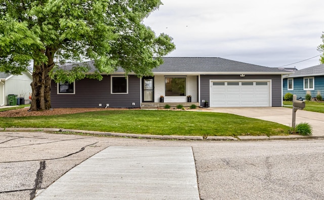 405 Joy Cir, Gilbert, IA 50105 - single story home with a front lawn, a garage, driveway, and a shingled roof
