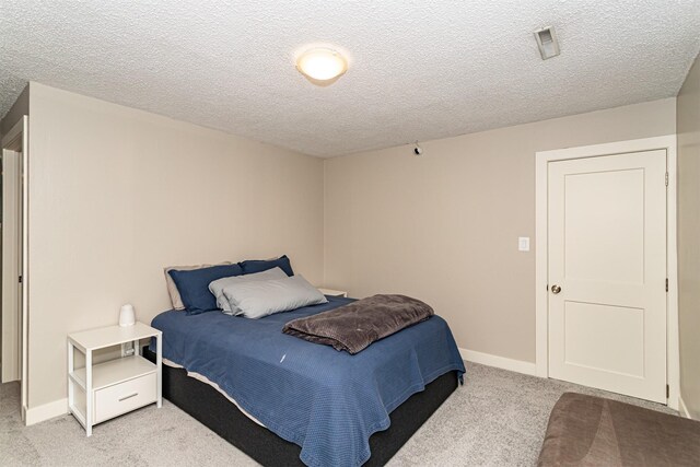 405 Joy Cir, Gilbert, IA 50105 - bedroom featuring carpet flooring, a textured ceiling, and baseboards