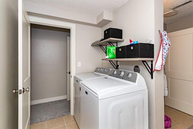 405 Joy Cir, Gilbert, IA 50105 - laundry area featuring washing machine and clothes dryer, light tile patterned floors, a textured ceiling, and light carpet