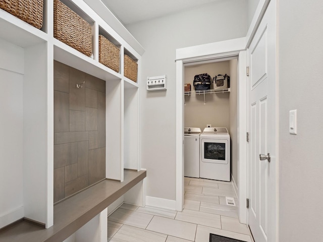 8876 Scarlet Dr, West Des Moines, IA 50266 - mudroom featuring washing machine and dryer, light tile patterned floors, and baseboards