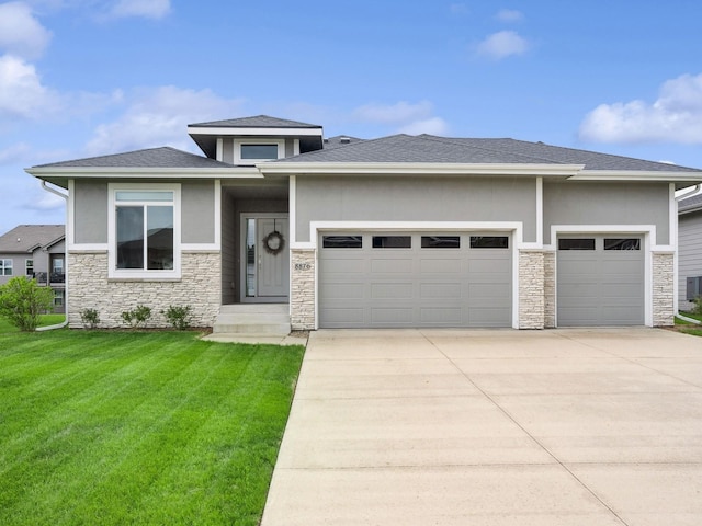 8876 Scarlet Dr, West Des Moines, IA 50266 - prairie-style home featuring a garage, stone siding, driveway, a front yard, and stucco siding