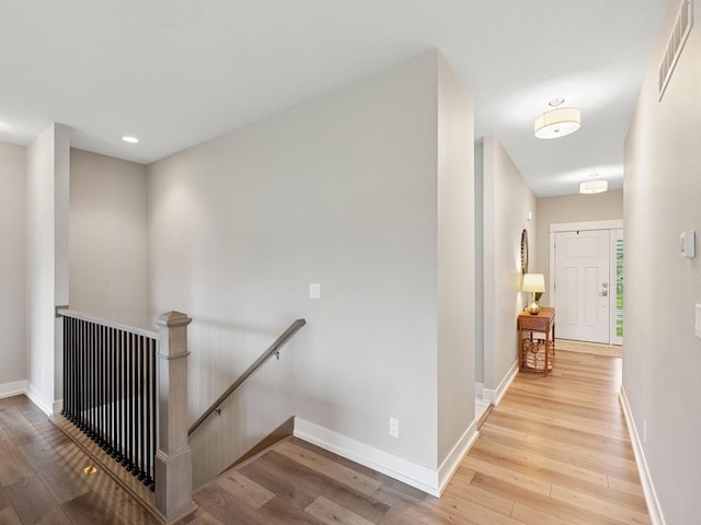 8876 Scarlet Dr, West Des Moines, IA 50266 - hallway with an upstairs landing, hardwood / wood-style floors, baseboards, and recessed lighting