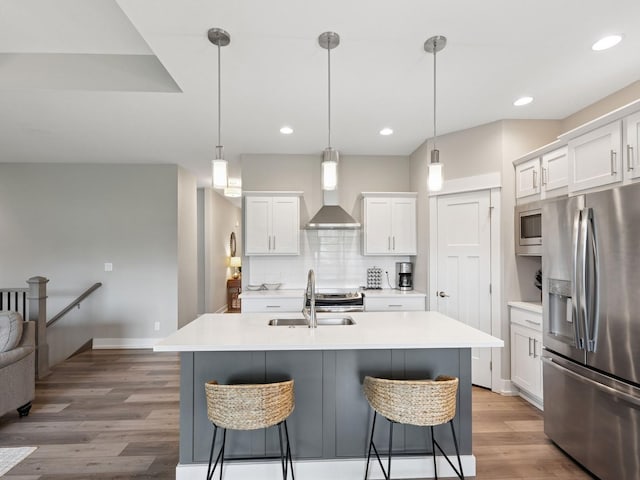 8876 Scarlet Dr, West Des Moines, IA 50266 - kitchen with stainless steel appliances, a sink, wall chimney exhaust hood, white cabinetry, and recessed lighting