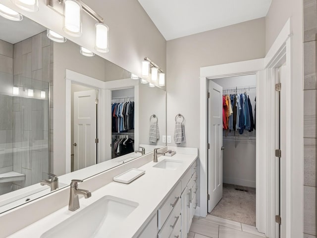 8876 Scarlet Dr, West Des Moines, IA 50266 - full bathroom with a walk in closet, double vanity, a stall shower, and tile patterned floors
