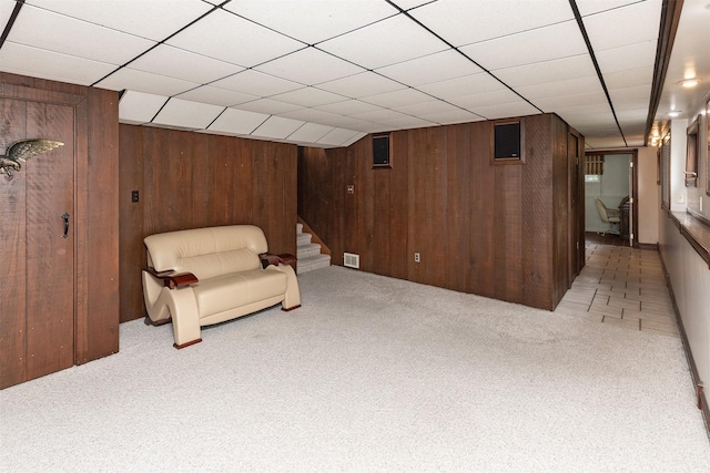 203 11th St, Dallas Center, IA 50063 - unfurnished room with wooden walls, light colored carpet, and stairs