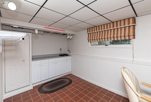 203 11th St, Dallas Center, IA 50063 - bar area with dark tile patterned floors, a paneled ceiling, and baseboards