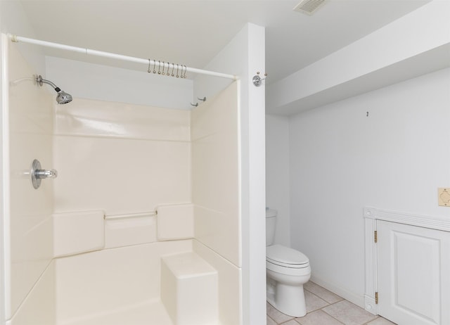 203 11th St, Dallas Center, IA 50063 - full bathroom with a shower, tile patterned floors, toilet, and baseboards