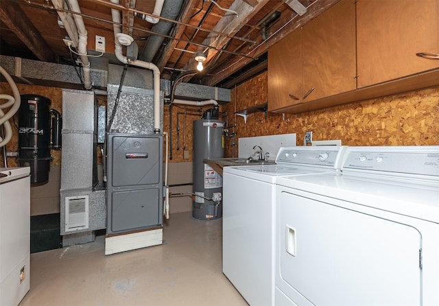 203 11th St, Dallas Center, IA 50063 - laundry area featuring washer and clothes dryer, gas water heater, cabinet space, and heating unit