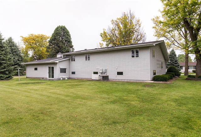 203 11th St, Dallas Center, IA 50063 - back of property with a yard and central AC unit