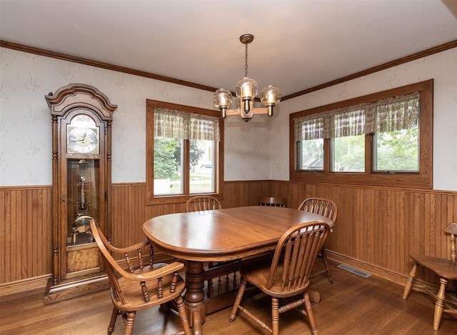 203 11th St, Dallas Center, IA 50063 - dining space with a wainscoted wall, light wood-type flooring, a chandelier, healthy amount of natural light, and wooden walls