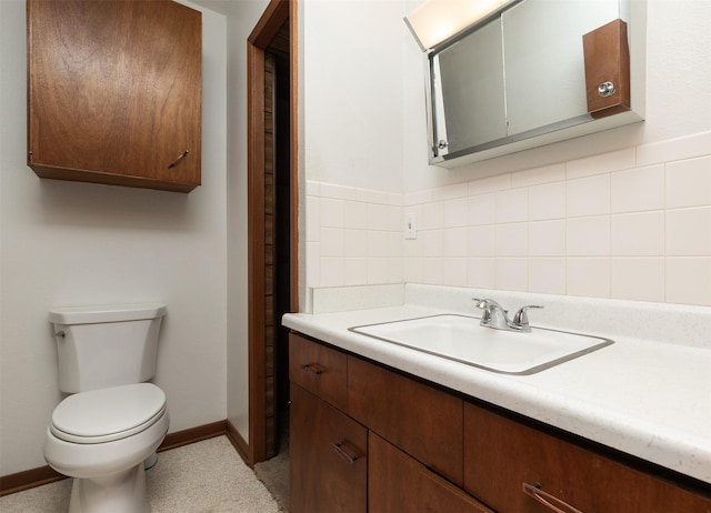203 11th St, Dallas Center, IA 50063 - bathroom with vanity, toilet, baseboards, and backsplash