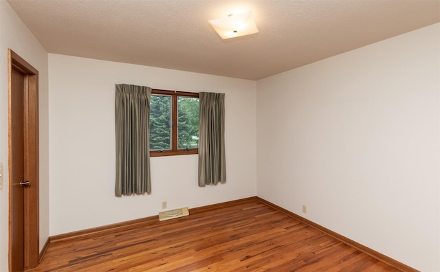 203 11th St, Dallas Center, IA 50063 - spare room with wood finished floors and baseboards