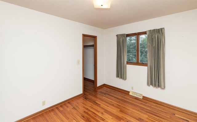 203 11th St, Dallas Center, IA 50063 - unfurnished bedroom with baseboards, light wood-style flooring, and a closet