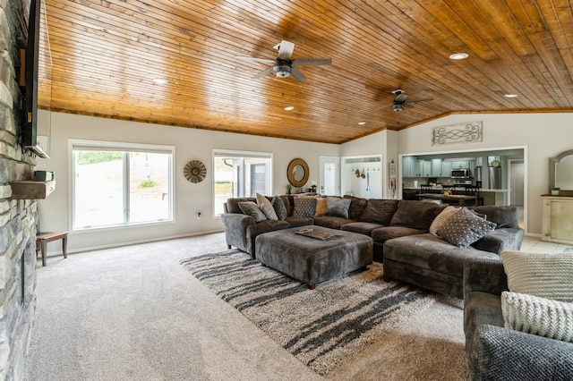 105 S Shore Dr, Montezuma, IA 50171 - living area with wooden ceiling, vaulted ceiling, a ceiling fan, light colored carpet, and a stone fireplace