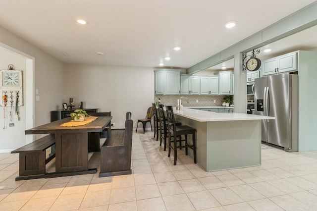 105 S Shore Dr, Montezuma, IA 50171 - kitchen featuring stainless steel appliances, a peninsula, light countertops, tasteful backsplash, and recessed lighting