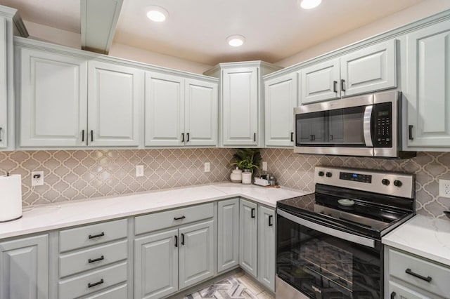 105 S Shore Dr, Montezuma, IA 50171 - kitchen with appliances with stainless steel finishes, gray cabinetry, light stone countertops, tasteful backsplash, and recessed lighting