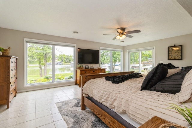 105 S Shore Dr, Montezuma, IA 50171 - bedroom with light tile patterned floors, access to exterior, and ceiling fan
