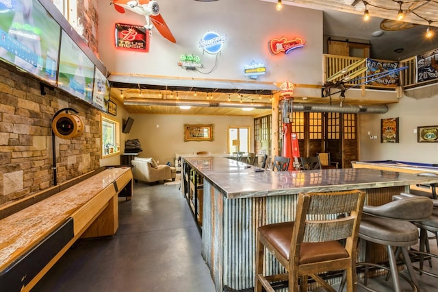105 S Shore Dr, Montezuma, IA 50171 - indoor dry bar with concrete floors and a towering ceiling