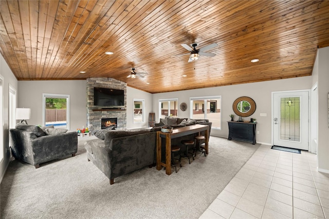 105 S Shore Dr, Montezuma, IA 50171 - carpeted living room with wooden ceiling, vaulted ceiling, tile patterned floors, ceiling fan, and a stone fireplace