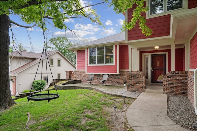 1645 NW 101st St, Clive, IA 50325 - view of front of home featuring brick siding and a front lawn