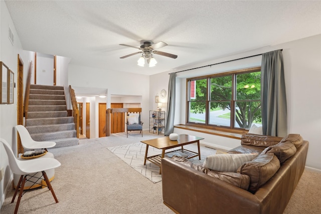 1645 NW 101st St, Clive, IA 50325 - carpeted living area with ceiling fan, stairway, baseboards, and a textured ceiling