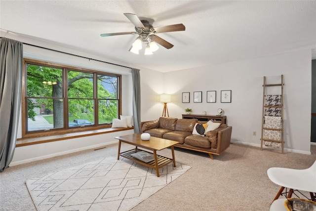 1645 NW 101st St, Clive, IA 50325 - living area with light carpet, ceiling fan, and baseboards