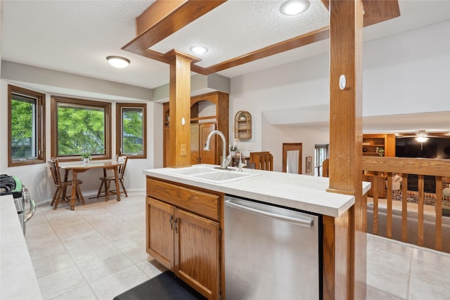 1645 NW 101st St, Clive, IA 50325 - kitchen with appliances with stainless steel finishes, a sink, a textured ceiling, light countertops, and light tile patterned floors