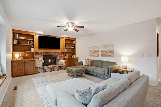 1645 NW 101st St, Clive, IA 50325 - living area featuring light colored carpet, a ceiling fan, baseboards, a fireplace, and built in features