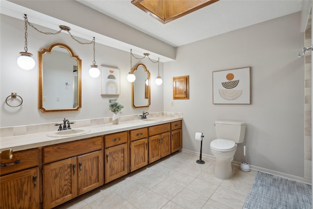 1645 NW 101st St, Clive, IA 50325 - full bath with double vanity, toilet, a skylight, tile patterned floors, and baseboards