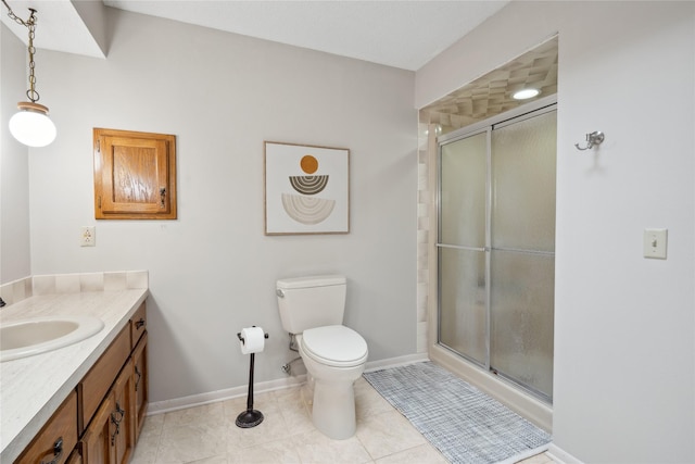 1645 NW 101st St, Clive, IA 50325 - bathroom featuring vanity, toilet, a shower stall, baseboards, and tile patterned flooring