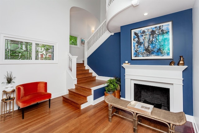 2606 Forest Dr, Des Moines, IA 50312 - living area with stairway, wood finished floors, recessed lighting, a fireplace, and arched walkways