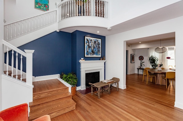 2606 Forest Dr, Des Moines, IA 50312 - living room featuring wood finished floors, stairway, and a fireplace with flush hearth
