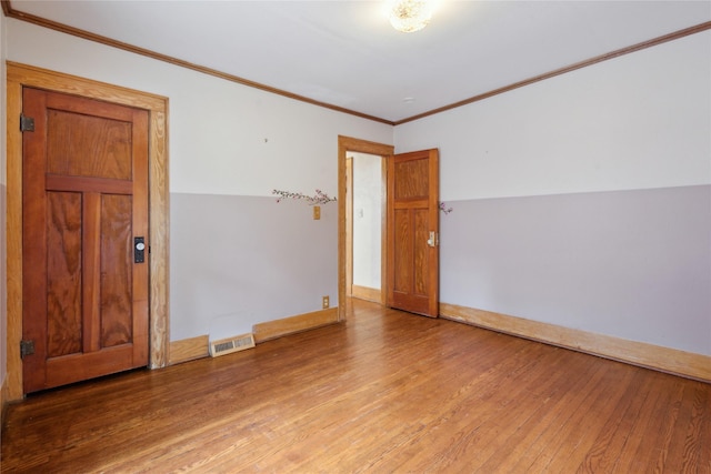 1439 46th St, Des Moines, IA 50311 - spare room featuring hardwood / wood-style flooring and crown molding