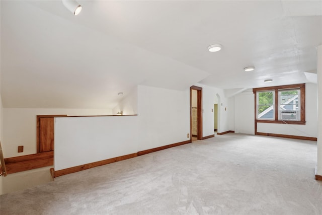 1439 46th St, Des Moines, IA 50311 - additional living space with light colored carpet, lofted ceiling, and baseboards