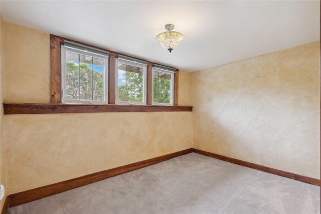 1439 46th St, Des Moines, IA 50311 - unfurnished room with baseboards and light carpet