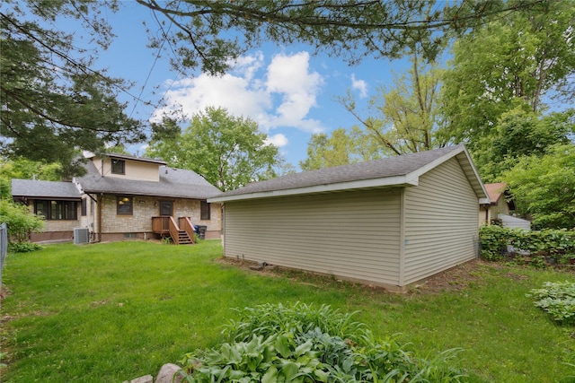 1439 46th St, Des Moines, IA 50311 - view of green lawn with central AC unit and an outbuilding