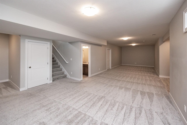 16004 Plum Dr, Urbandale, IA 50323 - finished below grade area with light carpet, stairway, and baseboards