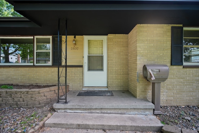 2407 E Tiffin Ave, Des Moines, IA 50317 - doorway to property featuring brick siding