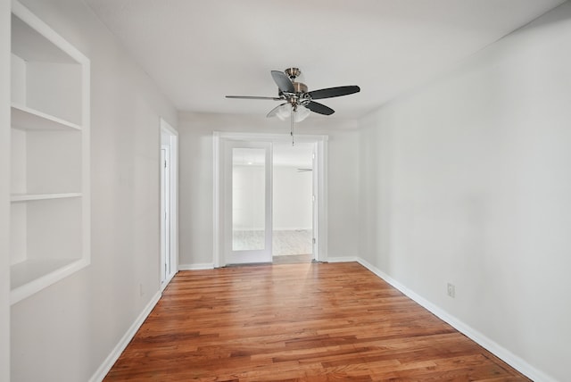 2407 E Tiffin Ave, Des Moines, IA 50317 - empty room featuring light wood-type flooring, ceiling fan, and baseboards