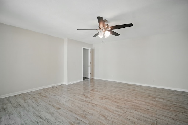 2407 E Tiffin Ave, Des Moines, IA 50317 - unfurnished room with a ceiling fan, wood finished floors, and baseboards