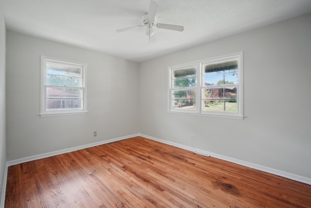 2407 E Tiffin Ave, Des Moines, IA 50317 - spare room with light wood-style flooring, baseboards, and ceiling fan