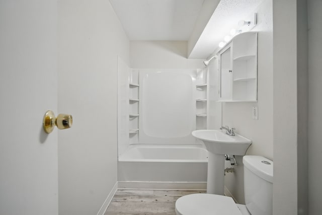 2407 E Tiffin Ave, Des Moines, IA 50317 - full bathroom featuring toilet, wood finished floors, and shower / bath combination