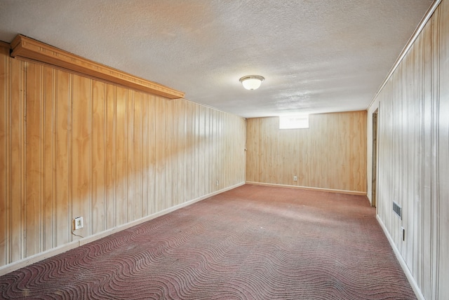 2407 E Tiffin Ave, Des Moines, IA 50317 - basement with a textured ceiling, wooden walls, and carpet floors
