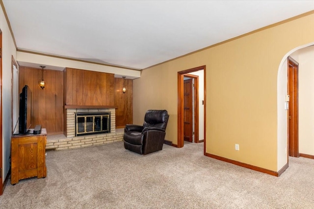862 40th Pl, Des Moines, IA 50312 - sitting room featuring arched walkways, carpet floors, ornamental molding, a fireplace, and baseboards