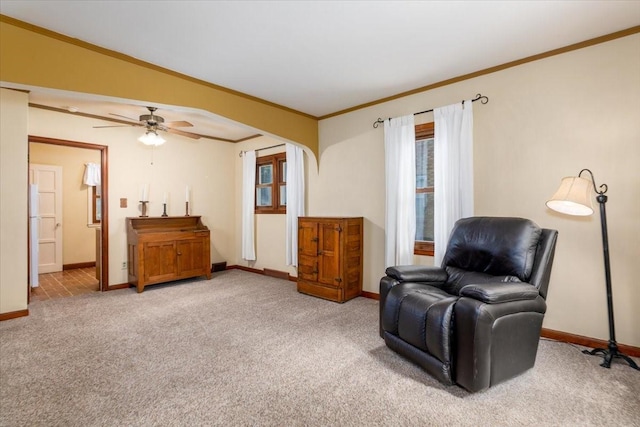 862 40th Pl, Des Moines, IA 50312 - living area with light carpet, baseboards, ornamental molding, and ceiling fan