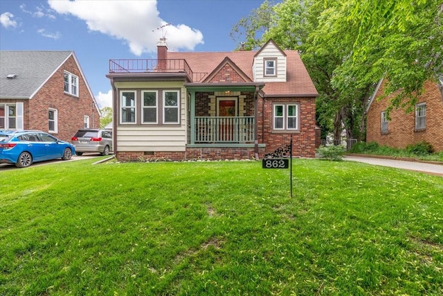 862 40th Pl, Des Moines, IA 50312 - view of front of house with a front lawn, a chimney, a balcony, and crawl space