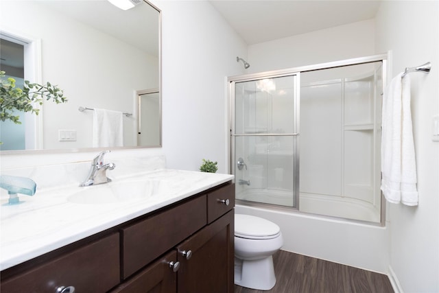 2357 Shadow Creek Cir, Des Moines, IA 50320 - full bath with vanity, toilet, wood finished floors, and shower / bath combination with glass door