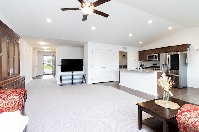 2357 Shadow Creek Cir, Des Moines, IA 50320 - living area with lofted ceiling, a ceiling fan, recessed lighting, baseboards, and dark wood-type flooring
