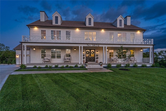 3834 NW 177th Ct, Clive, IA 50325 - view of front facade with a balcony, a porch, and a chimney